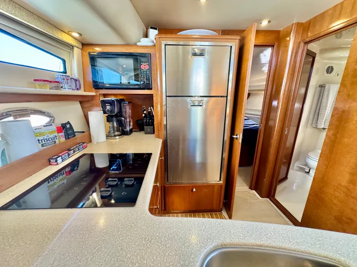  Yacht Photos Pics Luxurious 2005 Meridian 459 CMY yacht kitchen with modern appliances and sleek design.