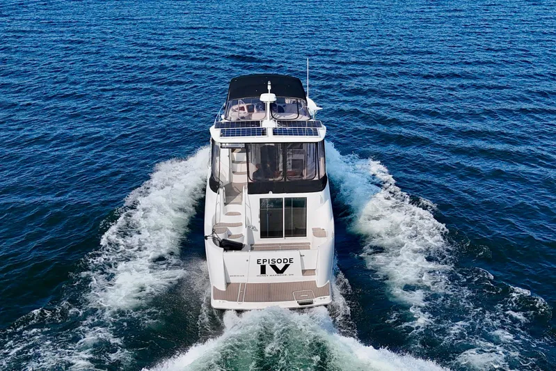  Yacht Photos Pics 2005 Meridian 459 CMY yacht cruising on open blue water.