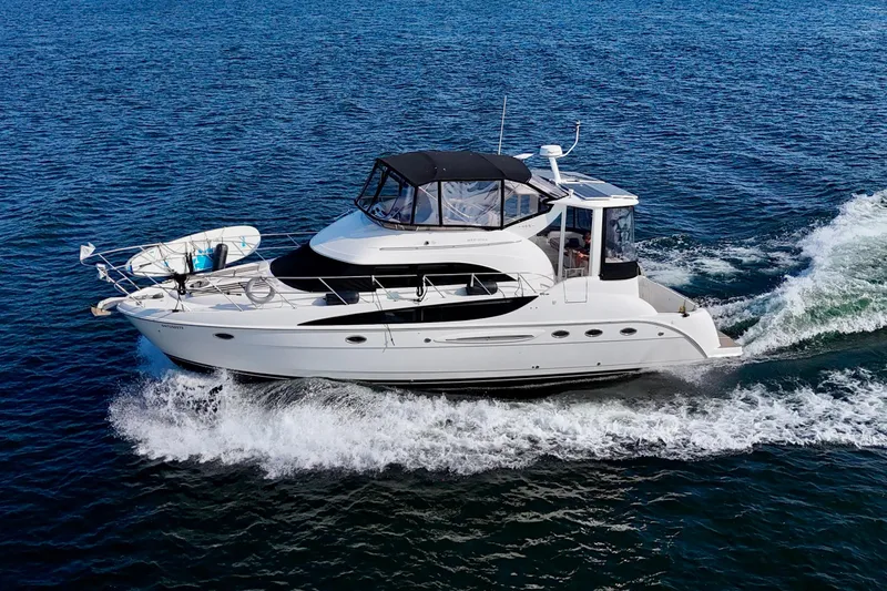  Yacht Photos Pics 2005 Meridian 459 CMY yacht cruising on open water, side view.