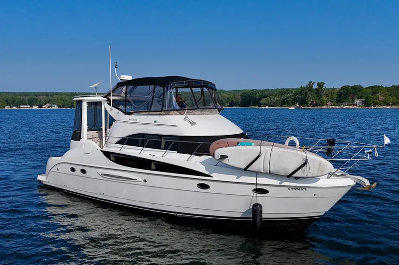  Yacht Photos Pics 2005 Meridian 459 CMY yacht on a serene lake with clear blue skies.