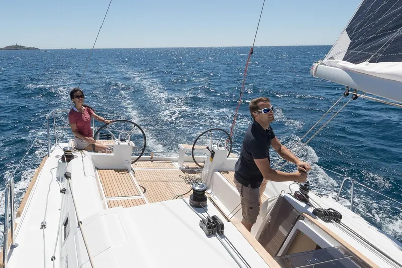 Wanderlust Yacht Photos Pics Two people sailing a 2019 Beneteau Oceanis 38.1 on open water.