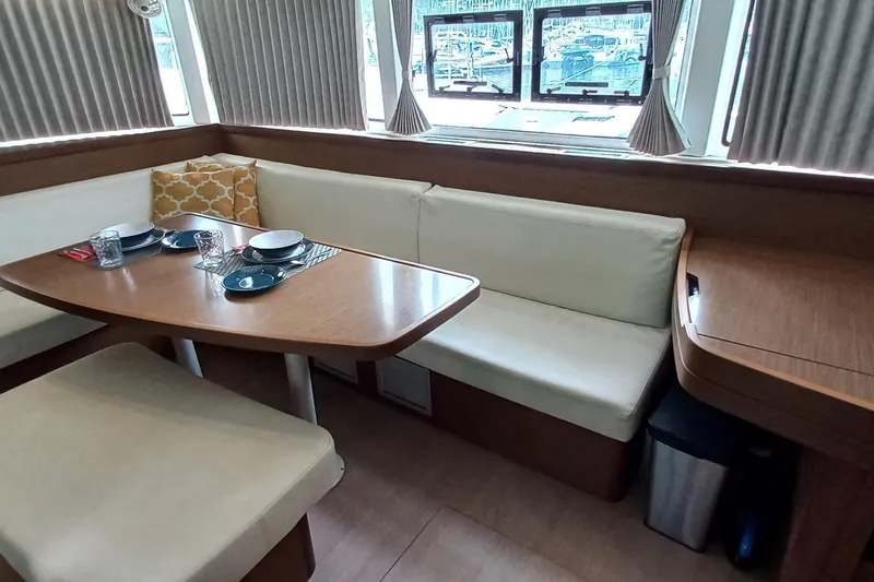 Always Sunday Yacht Photos Pics Interior of 2020 Lagoon 42 yacht with dining area and windows.