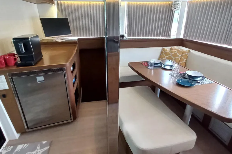 Always Sunday Yacht Photos Pics Interior of 2020 Lagoon 42 yacht with dining area and kitchenette.