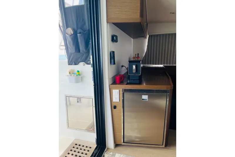 Always Sunday Yacht Photos Pics Interior of 2020 Lagoon 42 yacht featuring a compact kitchen area with appliances.