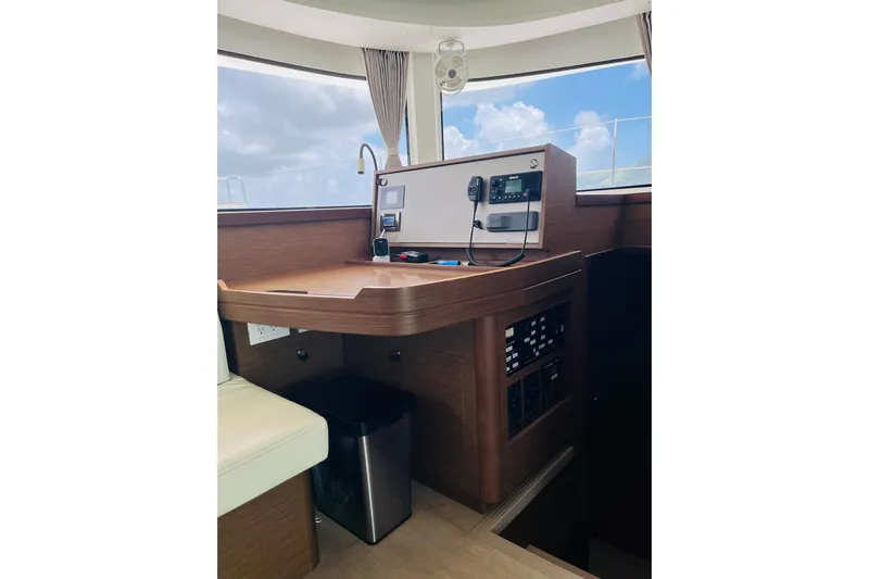 Always Sunday Yacht Photos Pics Interior view of 2020 Lagoon 42 yacht's navigation station with control panel.