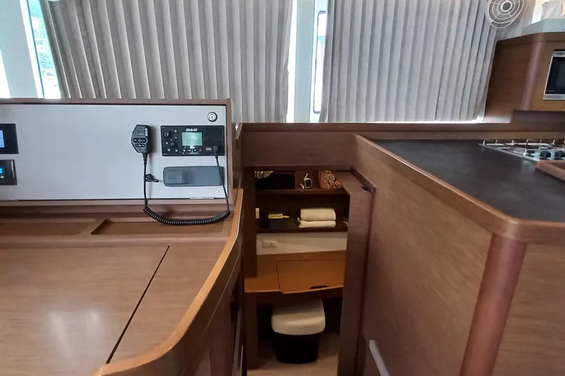 Always Sunday Yacht Photos Pics Interior of 2020 Lagoon 42 yacht with navigation equipment and wooden cabinetry.