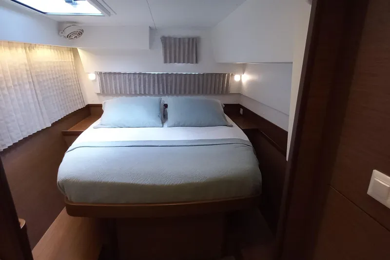 Always Sunday Yacht Photos Pics Luxurious cabin interior of 2020 Lagoon 42 catamaran with cozy bed and ambient lighting.