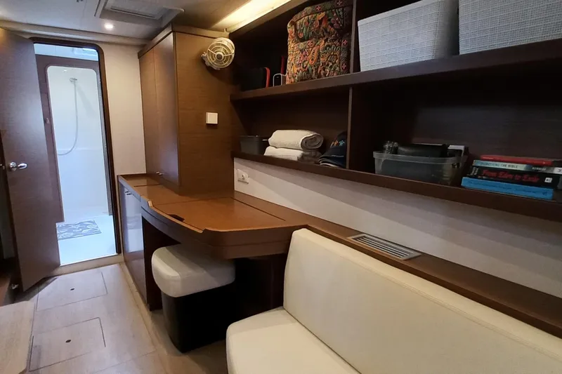 Always Sunday Yacht Photos Pics Interior of 2020 Lagoon 42 yacht with wooden shelves, seating, and bathroom.