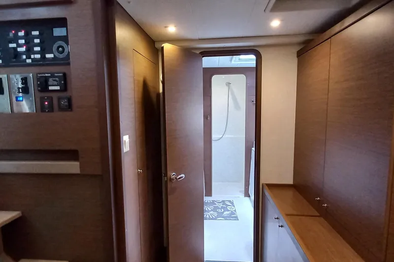 Always Sunday Yacht Photos Pics Interior of 2020 Lagoon 42 yacht showing hallway and bathroom with modern wood finish.
