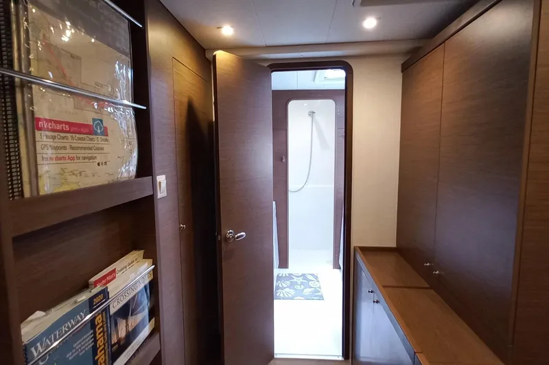 Always Sunday Yacht Photos Pics Interior of 2020 Lagoon 42 yacht with wooden cabinetry and visible shower area.