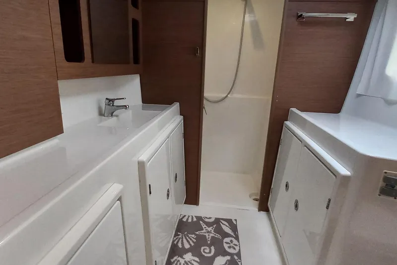 Always Sunday Yacht Photos Pics Interior of 2020 Lagoon 42 yacht bathroom with modern fixtures and wood accents.
