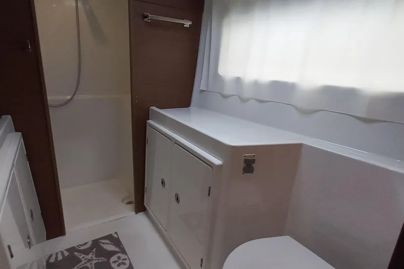 Always Sunday Yacht Photos Pics Interior of 2020 Lagoon 42 yacht bathroom with shower and storage cabinets.