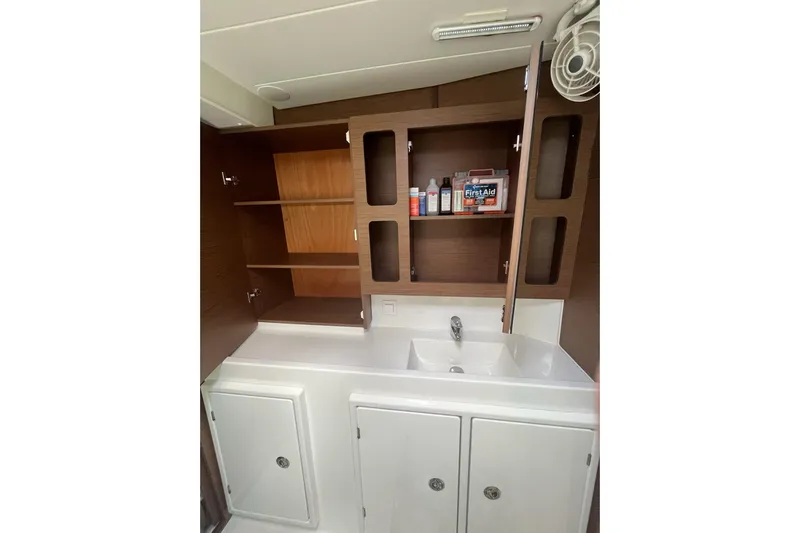 Always Sunday Yacht Photos Pics Bathroom interior of 2020 Lagoon 42 yacht with sink and storage cabinets.