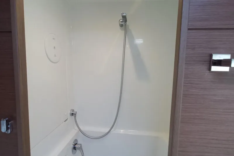 Always Sunday Yacht Photos Pics Shower area inside a 2020 Lagoon 42 yacht, featuring modern fixtures and wood paneling.