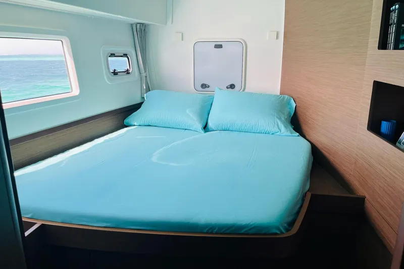 Always Sunday Yacht Photos Pics Cozy bedroom in 2020 Lagoon 42 catamaran with ocean view and blue bedding.