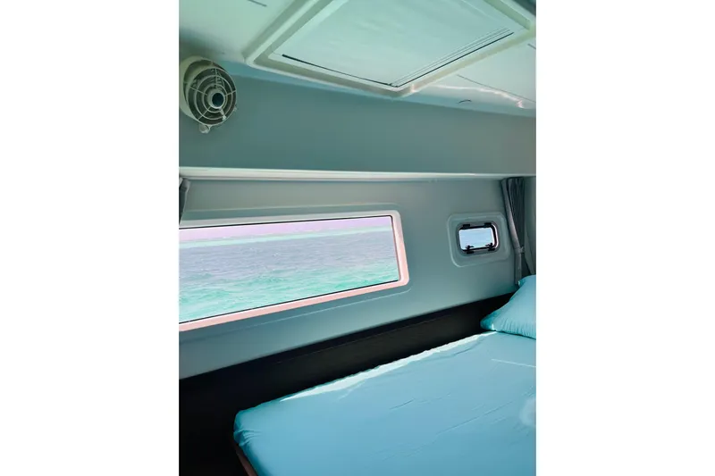 Always Sunday Yacht Photos Pics Interior cabin view of 2020 Lagoon 42 catamaran with ocean view through window.
