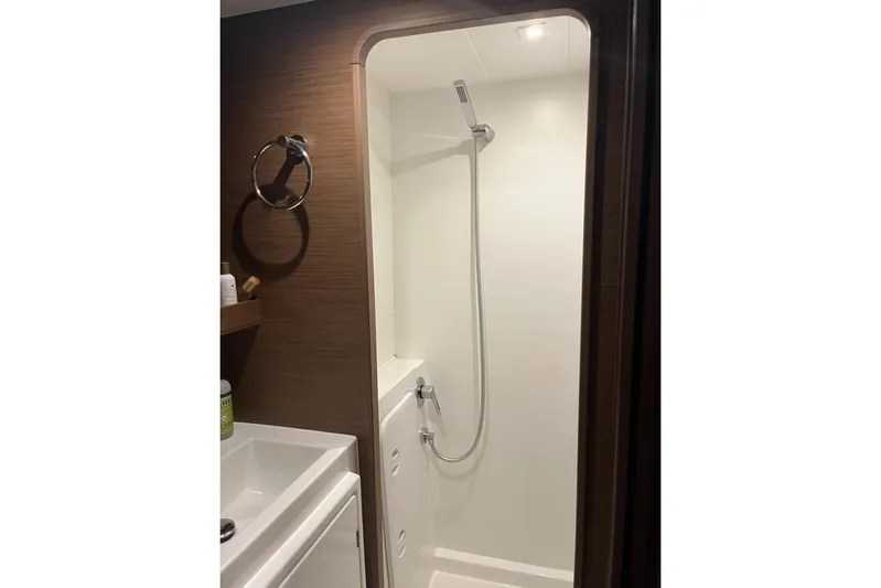 Always Sunday Yacht Photos Pics Bathroom shower area in a 2020 Lagoon 42 yacht, featuring modern fixtures.