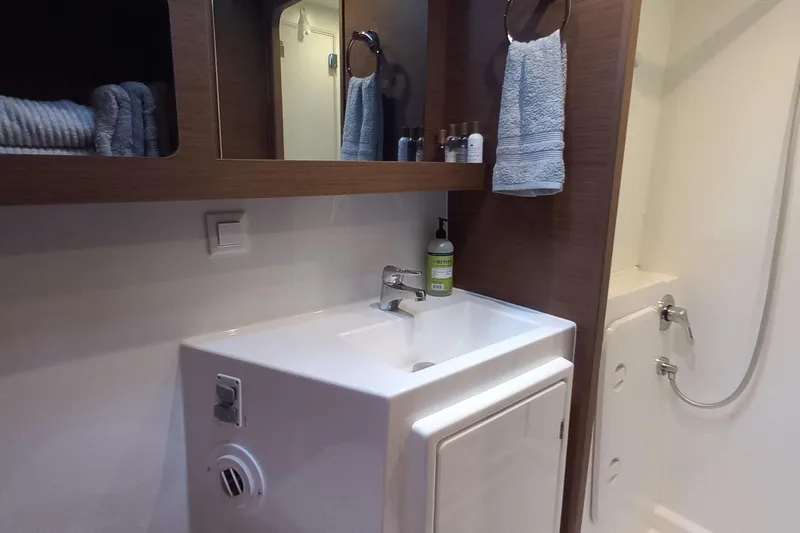 Always Sunday Yacht Photos Pics Modern bathroom in a 2020 Lagoon 42 yacht with sink, mirror, and shower.