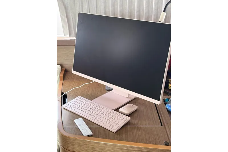 Always Sunday Yacht Photos Pics Modern computer setup on Lagoon 42 yacht, 2020 model, featuring monitor, keyboard, and mouse.