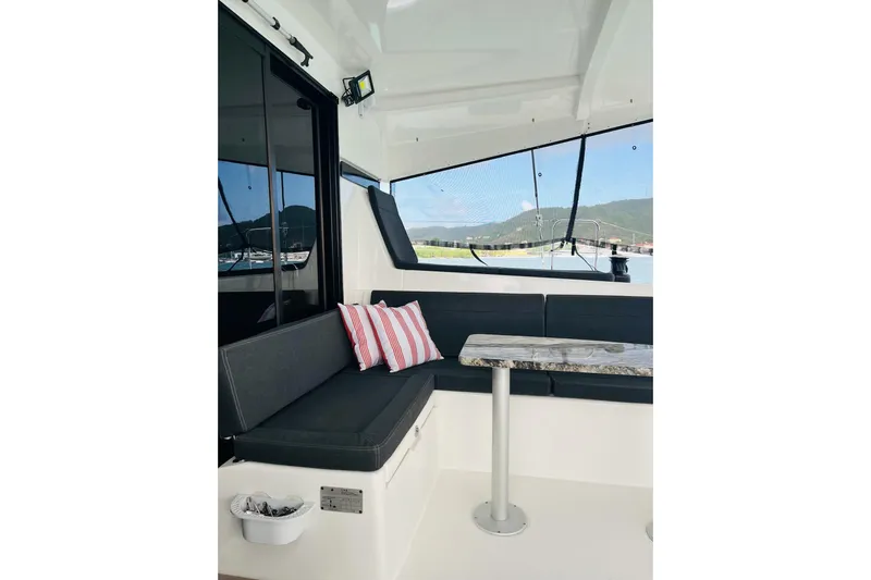 Always Sunday Yacht Photos Pics Interior of 2020 Lagoon 42 catamaran with seating, table, and striped cushions.