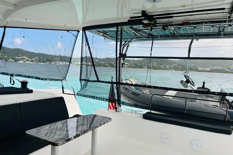 Always Sunday Yacht Photos Pics Interior view of 2020 Lagoon 42 catamaran with scenic ocean backdrop.