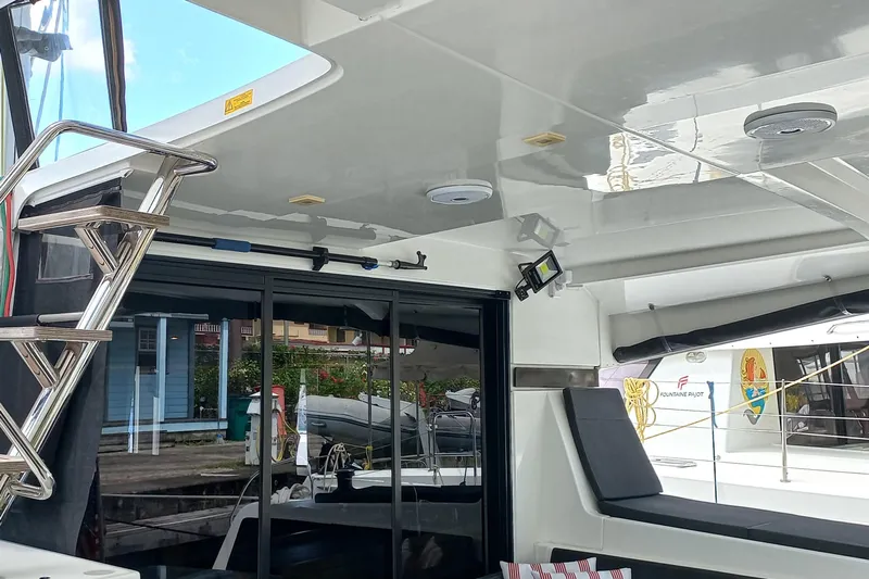 Always Sunday Yacht Photos Pics Interior view of a 2020 Lagoon 42 catamaran with seating and ladder.