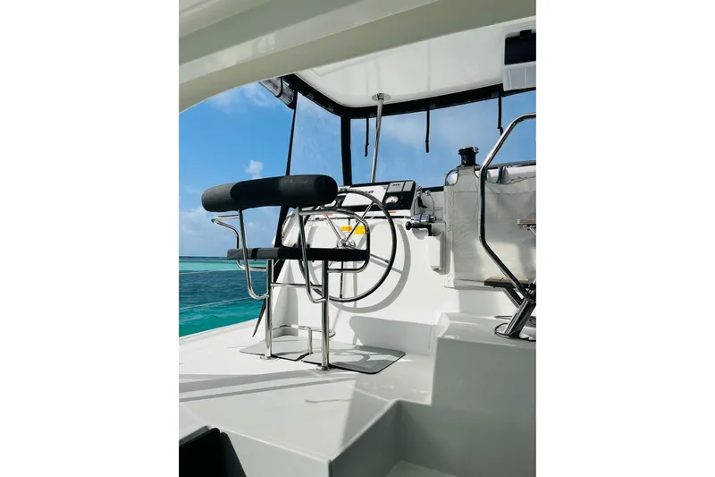 Always Sunday Yacht Photos Pics Helm of 2020 Lagoon 42 catamaran with ocean view and clear blue sky.