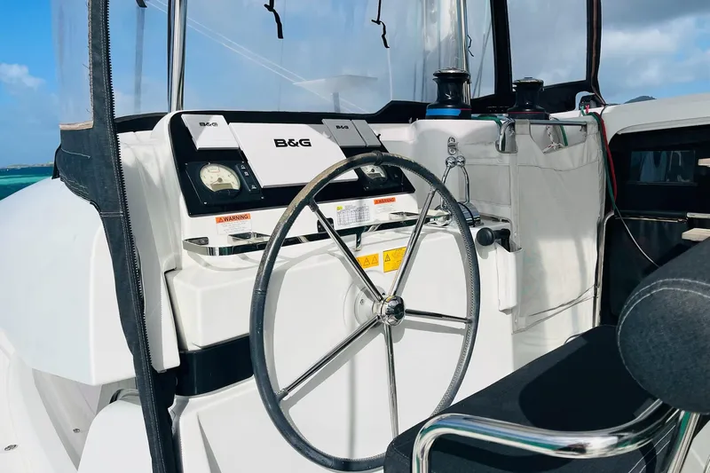 Always Sunday Yacht Photos Pics Steering wheel and controls of a 2020 Lagoon 42 catamaran, featuring B&G navigation equipment.