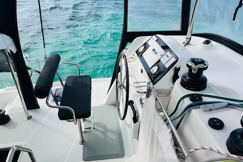 Always Sunday Yacht Photos Pics Cockpit of 2020 Lagoon 42 catamaran with steering wheel and ocean view.