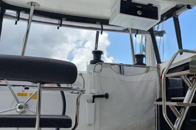 Always Sunday Yacht Photos Pics Interior view of 2020 Lagoon 42 catamaran cockpit with seating and equipment.