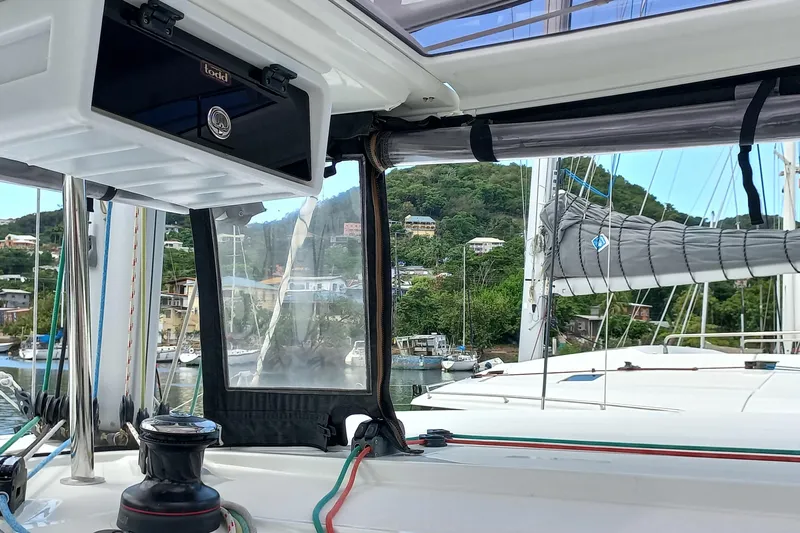 Always Sunday Yacht Photos Pics Cockpit view of 2020 Lagoon 42 catamaran docked in a scenic marina.