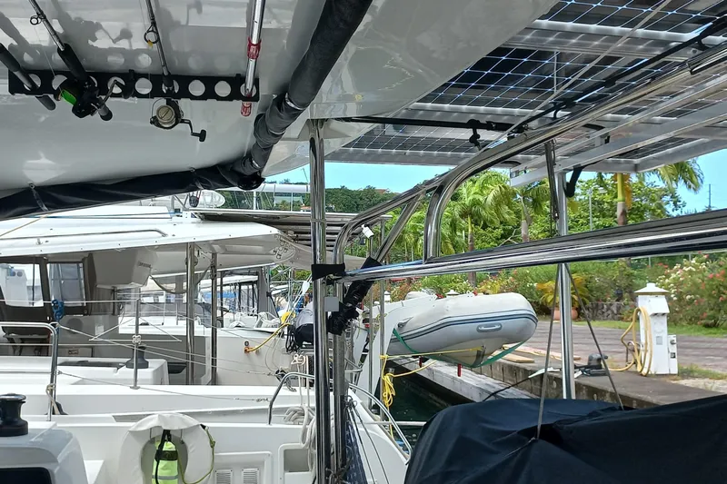 Always Sunday Yacht Photos Pics 2020 Lagoon 42 catamaran docked, featuring solar panels and a dinghy.