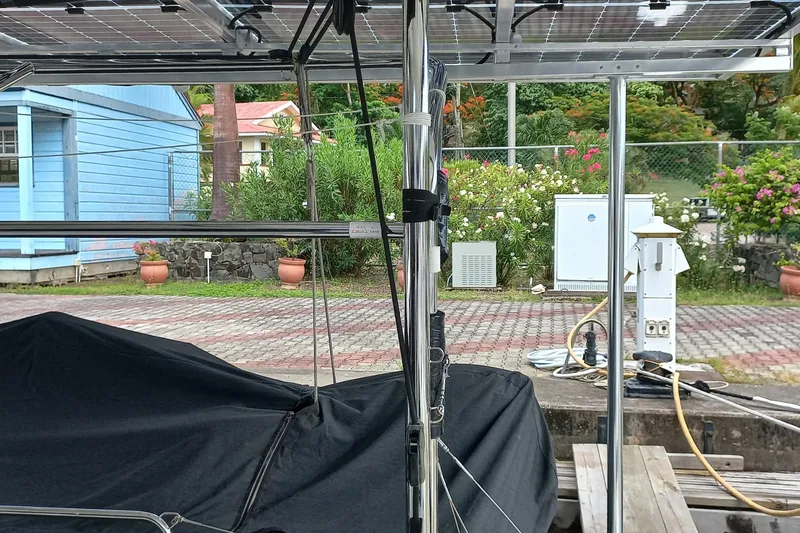 Always Sunday Yacht Photos Pics Solar panels on a 2020 Lagoon 42 catamaran docked near a garden and blue building.