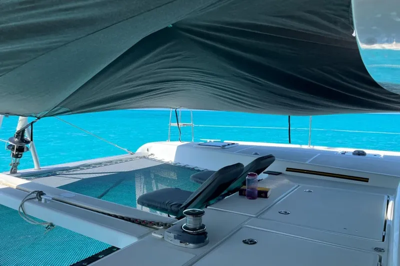 Always Sunday Yacht Photos Pics Luxurious Lagoon 42 catamaran deck with sunshade, 2020 model, overlooking turquoise waters.
