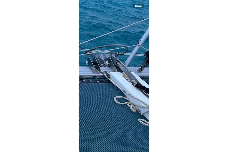 Always Sunday Yacht Photos Pics Anchor and ropes on a 2020 Lagoon 42 catamaran, floating on blue water.