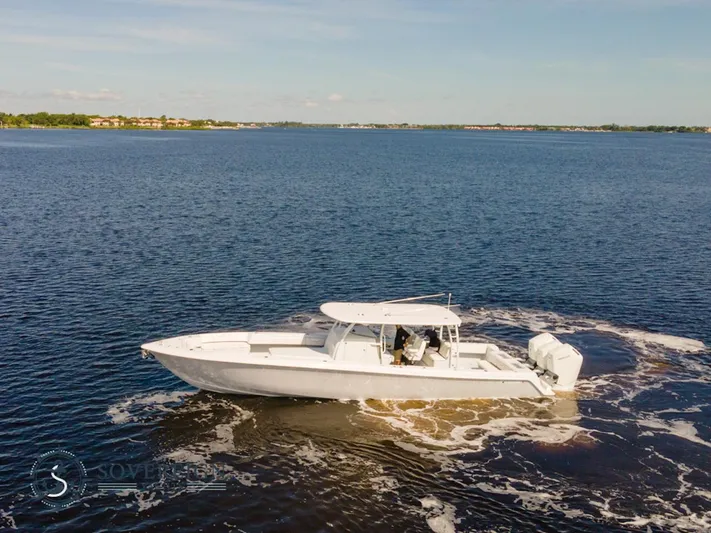 44-023 Yacht Photos Pics 2024 Contender 44 CB boat cruising on a calm lake.