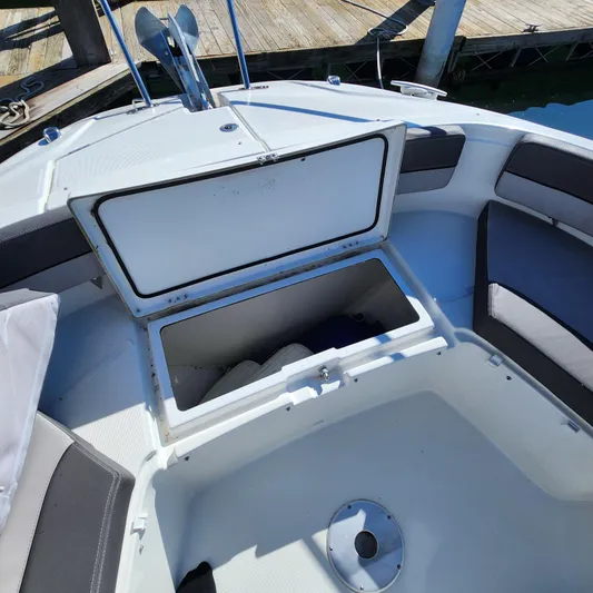 Hanolei Yacht Photos Pics Open storage compartment on 2021 Jeanneau 9.0 CC boat deck, with cushioned seating.