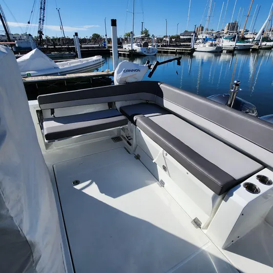 Hanolei Yacht Photos Pics 2021 Jeanneau 9.0 CC boat interior with cushioned seating at marina.