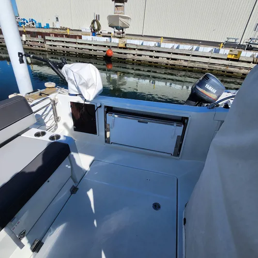 Hanolei Yacht Photos Pics 2021 Jeanneau 9.0 CC boat interior with Yamaha motor, docked by the water.