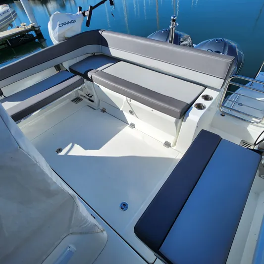 Hanolei Yacht Photos Pics 2021 Jeanneau 9.0 CC boat interior with cushioned seating and sleek design.