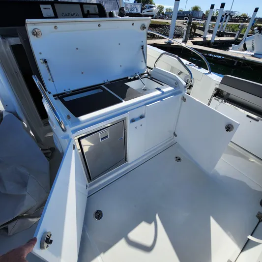 Hanolei Yacht Photos Pics 2021 Jeanneau 9.0 CC boat interior with open storage compartments and seating area.