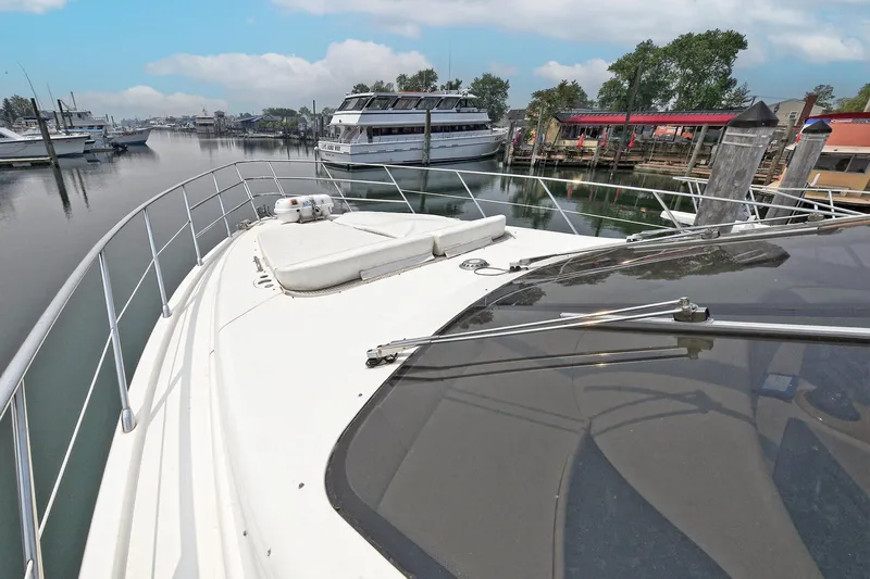  Yacht Photos Pics 2003 Azimut 62 yacht docked in a serene marina setting.