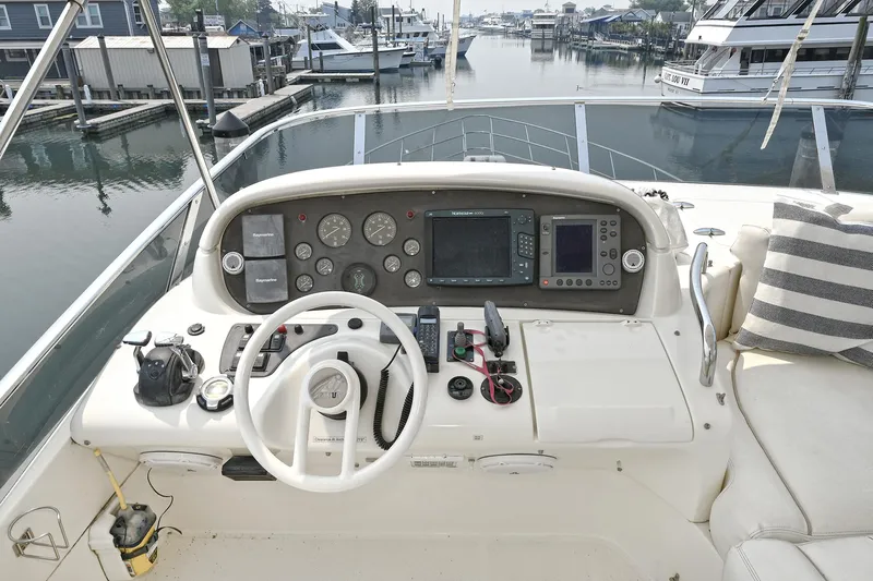  Yacht Photos Pics Helm of 2003 Azimut 62 yacht with navigation instruments and steering wheel.
