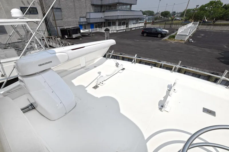  Yacht Photos Pics 2003 Azimut 62 yacht deck with urban backdrop and parked car.