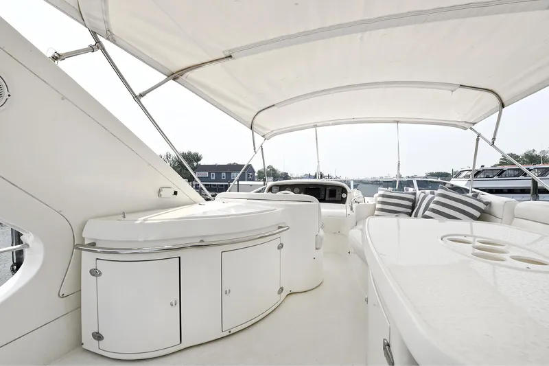  Yacht Photos Pics Luxurious 2003 Azimut 62 yacht deck with seating and canopy.