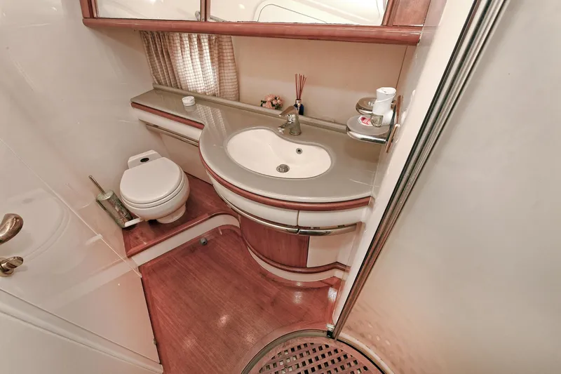 Yacht Photos Pics Luxurious bathroom in a 2003 Azimut 62 yacht, featuring elegant fixtures and wood accents.