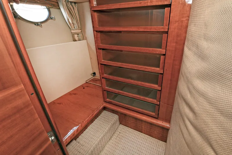  Yacht Photos Pics Interior of 2003 Azimut 62 yacht with wooden cabinetry and carpeted flooring.