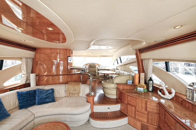  Yacht Photos Pics Luxurious interior of a 2003 Azimut 62 yacht with elegant wood finishes and plush seating.