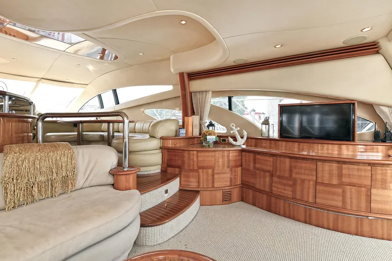  Yacht Photos Pics Luxurious interior of a 2003 Azimut 62 yacht with elegant wood finishes and plush seating.