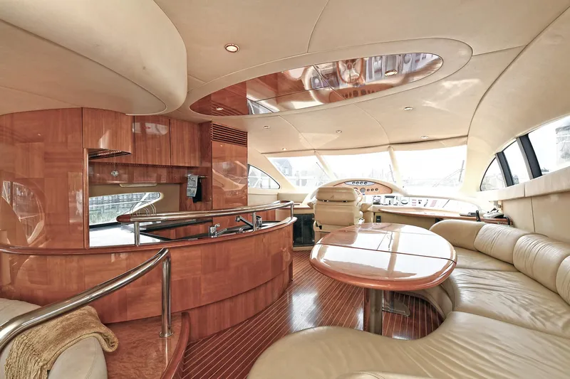  Yacht Photos Pics Luxurious interior of a 2003 Azimut 62 yacht with elegant wood finishes and plush seating.